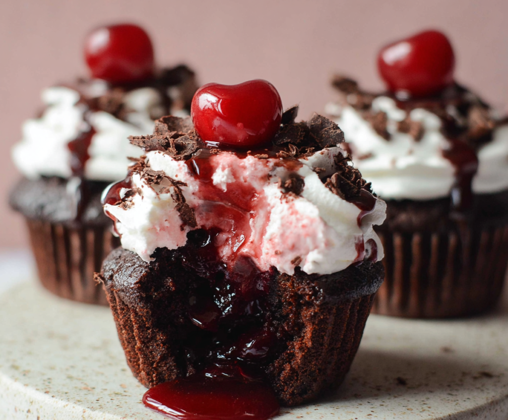 Delicious Black Forest Cupcakes with chocolate, cherries, and whipped cream frosting.