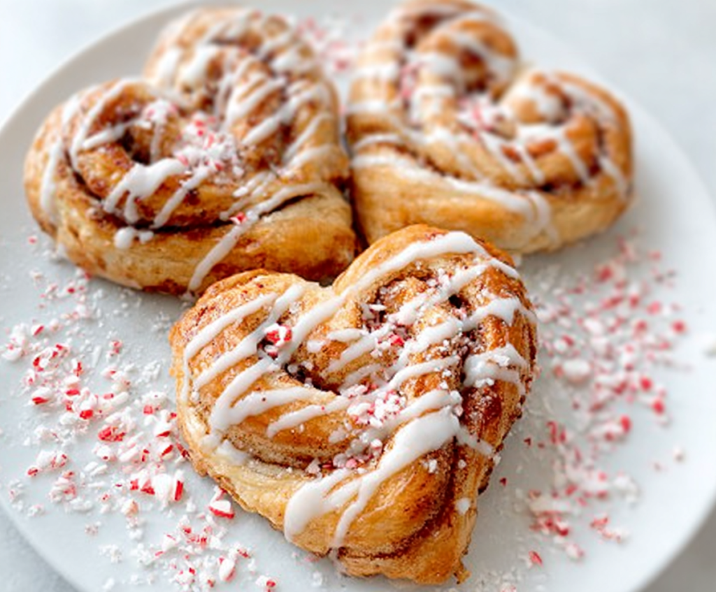 Delicious heart-shaped cinnamon rolls with swirls of cinnamon and sugar, perfect for breakfast or dessert.